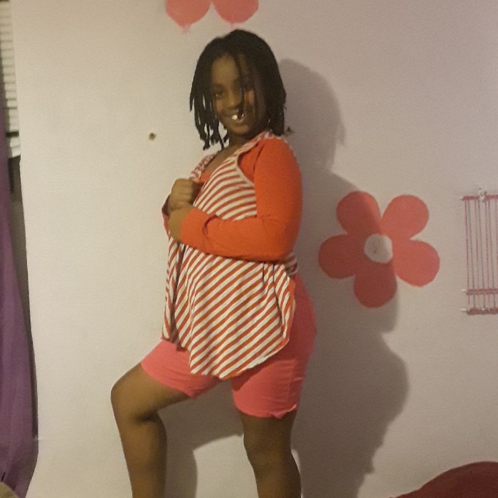 A red shirt and pink shorts